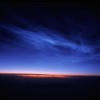 Noctilucent Clouds taken from 36,000 feet above the South of Nunivak Island, Alaska on June 20, 2006. (John Boardman/NASA)