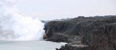 The rocky shelf at the base of the sea cliff is all that remains of the Kamokuna lava delta following the New Year's Eve collapse. (USGS HVO)