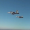 The drones were launched from three F/A-18 Super Hornet fighter jets. (YouTube)