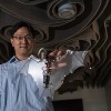 Soon-Jo Chung, associate professor of aerospace and Bren Scholar at Caltech, holds the Bat Bot.