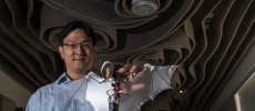 Soon-Jo Chung, associate professor of aerospace and Bren Scholar at Caltech, holds the Bat Bot.