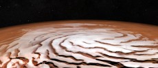 Perspective view of the Mars north polar ice cap and its distinctive dark troughs forming a spiral-like pattern. (ESA/DLR/FU Berlin; NASA MGS MOLA Science Team)