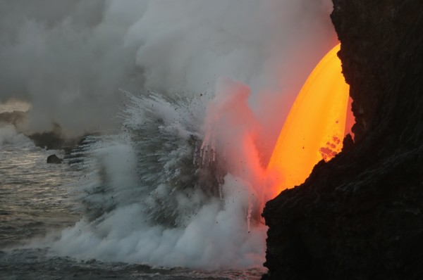 An open lava stream continues to pour out of the lava tube into the ocean. (USGS Hawaii Volcano Observatory)