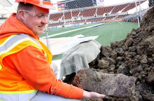 Woodburn High School science teacher Dave Ellingson holds part of the pelvis of a mammoth found at an OSU construction site. 