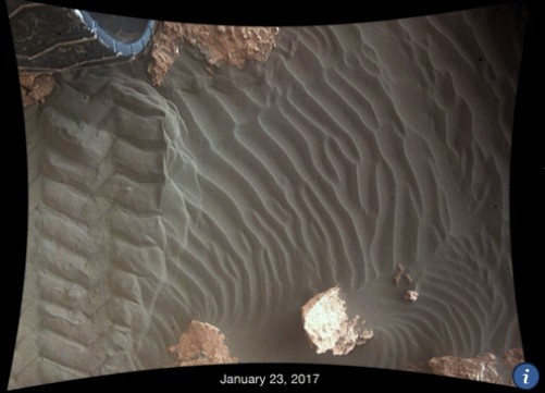 This image shows effects of one Martian day of wind blowing sand underneath NASA's Curiosity Mars rover on a non-driving day for the rover.