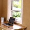 A laptop and pen are placed on the table while the writer makes his preparations. 