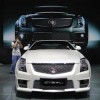 A photographer takes pictures of a Cadillac CTS-V Coupe during the media preview of 10th China International Automobile Exhibition in Guangzhou.