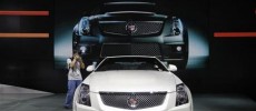 A photographer takes pictures of a Cadillac CTS-V Coupe during the media preview of 10th China International Automobile Exhibition in Guangzhou.