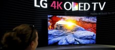 A visitor looks at LG 4K OLED TV screen at the IFA consumer technology fair in Berlin.