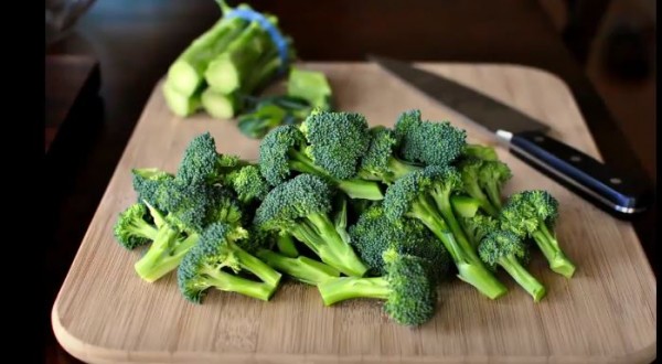 Broccolis are being prepared for cooking. 