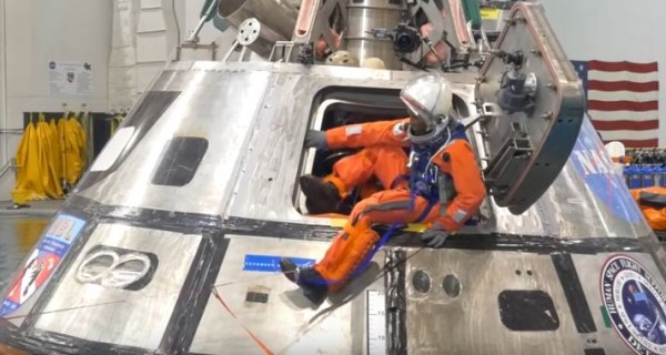 A space crew prepares to exit from the space capsule during a test. (YouTube)