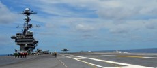 An F/A-18F Super Hornet conducts touch-and-go flight operations off the deck of USS George Washington while testing MAGIC CARPET.       