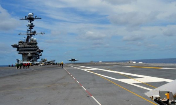 An F/A-18F Super Hornet conducts touch-and-go flight operations off the deck of USS George Washington while testing MAGIC CARPET.       