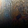 This enhanced-color image of a mysterious dark spot on Jupiter seems to reveal a Jovian “galaxy” of swirling storms.
