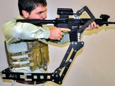 An assault rifle is fired using a prototype body-mount device.                 