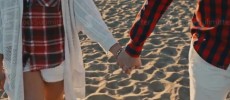 Young Couple holding hands at sunset on beach