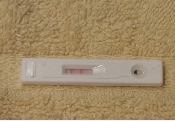 A pregnancy test kit displays positive. (YouTube)