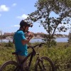 A man stops from riding his bike to drink some water to quench his thirst and cool himself. (YouTube)