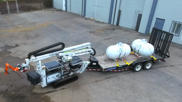 The Digital Construction Platform has  a vehicle carrying a large, industrial robotic arm that has a smaller, precision-motion robotic arm at its end. (YouTube)
