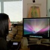 A woman works using two computer monitors. (YouTube)
