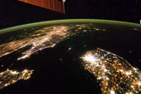 The Korean Peninsula at night. North Korea is almost completely dark, the bright spot is Pyongyang