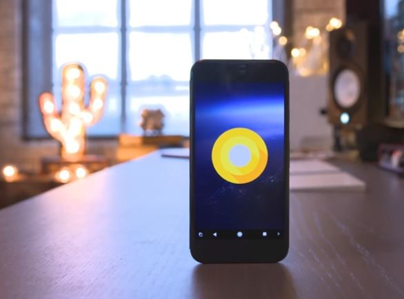 A smartphone is displaying the logo of the latest Google Android OS.
