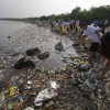 Volunteers collect garbage along the shore off Manila Bay, during an environmental project marking World Oceans Day in Paranaque, Metro Manila.