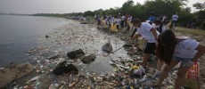 Volunteers collect garbage along the shore off Manila Bay, during an environmental project marking World Oceans Day in Paranaque, Metro Manila.