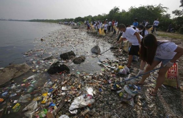 Volunteers collect garbage along the shore off Manila Bay, during an environmental project marking World Oceans Day in Paranaque, Metro Manila.