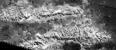 The trio of ridges on Titan known as Mithrim Montes is home to the hazy Saturnian moon's tallest peak.
