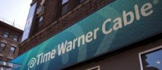 A Time Warner Cable sign and logo are seen on the exterior of a Time Warner store.