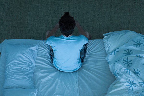 Man Sitting on Bed