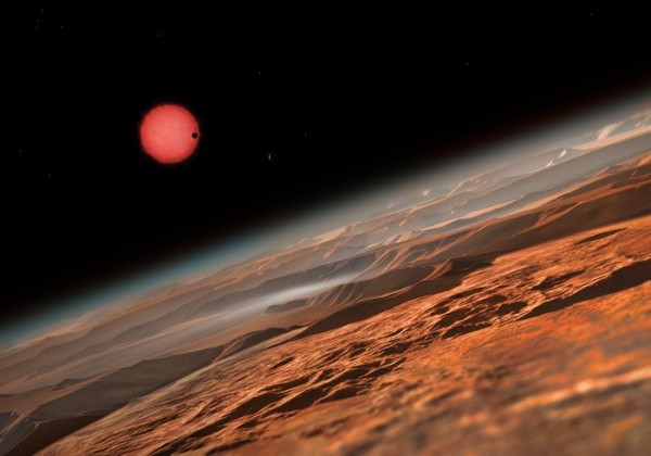 This artist’s impression shows an imagined view from close to one of the three planets orbiting an ultracool dwarf star just 40 light-years from Earth that were discovered using the TRAPPIST telescope at ESO’s La Silla Observatory. 