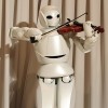 Toyota's violin-playing robot plays at Universal Design Showcase on December 6,2007 in Tokyo, Japan. The robot, which has 17 joints in both arms, uses precise control to play the violin. 