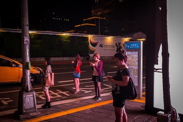 People play Pokemon Go on their smartphones on August 7, 2016 in Taipei, Taiwan.