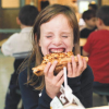 Students Eat Lunch In The School Cafeteria