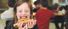 Students Eat Lunch In The School Cafeteria