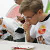 A man eating a chili pepper. A new study has concluded that the preference among some people for chili pepper and other foods abhorred by others is the result of an acquired taste.