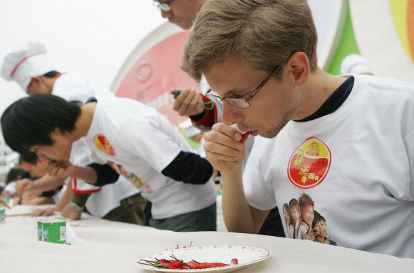 A man eating a chili pepper. A new study has concluded that the preference among some people for chili pepper and other foods abhorred by others is the result of an acquired taste.