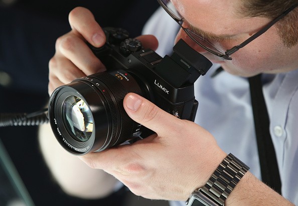 A visitor tries out the Lumix DMC-GX8 digital camera at the Panasonic stand at the 2015 IFA consumer electronics and appliances trade fair in Berlin, Germany.
