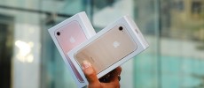 One of the first customers to buy a new iPhone walks out of an Apple store in Manhattan in New York City.