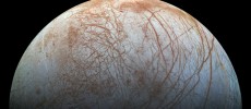 Europa, a moon of Jupiter, appears as a thick crescent in this enhanced-color image from NASA's Galileo spacecraft, which has been orbiting Jupiter since 1995.