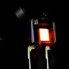 A proof-of-concept device built by MIT researchers demonstrates the principle of a two-stage process to make incandescent bulbs more efficient.