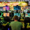 Visitors try out the massively multiplayer online role-playing game 'World Of Warcraft' at the Blizzard Entertainment stand at the Gamescom 2016 gaming trade fair during the media day in Cologne, Germ