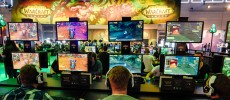 Visitors try out the massively multiplayer online role-playing game 'World Of Warcraft' at the Blizzard Entertainment stand at the Gamescom 2016 gaming trade fair during the media day in Cologne, Germ