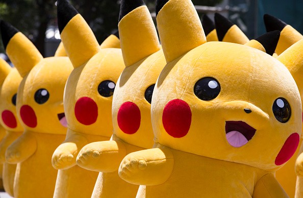 Performers dressed as Pikachu, a character from Pokemon series game titles, march during the Pikachu Outbreak event hosted by The Pokemon Co. in Yokohama, Japan. 