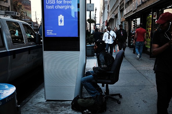 A man uses one of the new Wi-Fi kiosks that offer free web surfing, phone calls and a charging station in New York City. 