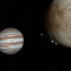 This is an artist's concept of the moon Europa, at right, with water-ice plumes erupting from its lower left limb at the 7 o'clock position