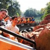 Guests ride aboard the Big Thunder Mountain Railroad roller coaster in Disney Land California.