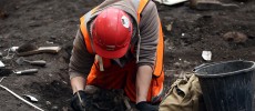 An archaeologist at work unearthing buried remains.